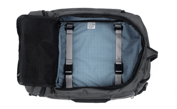 An open Techonaut 30 with a Nebulous Grey (dark grey) exterior and an Tidal (pale blue) interior.